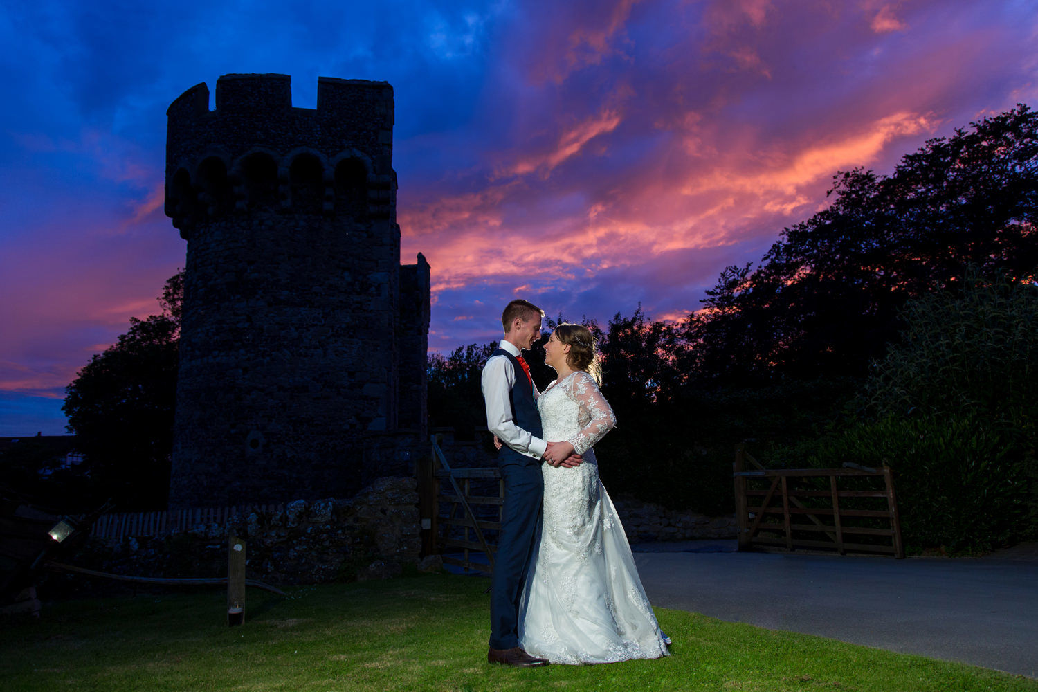 Cooling Castle Barns bride and groom with sunset